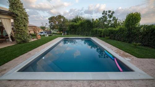 a swimming pool in the backyard of a house at Villa MERAVIGLIA, heated pool, 16 km from the sea in Ascoli Piceno