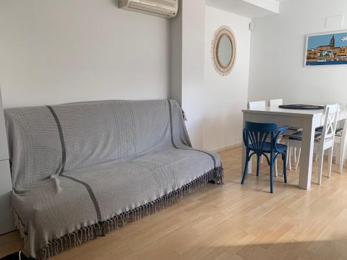 a living room with a couch and a table at Apartaments Muntaner I in Palamós