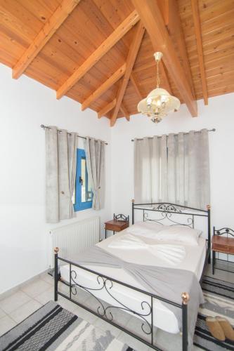 a bedroom with a bed and a wooden ceiling at Samian Thalia Apartment in Pagóndas