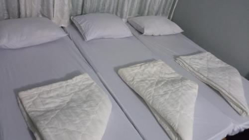 two twin beds sitting next to each other at Enjoy Mekong Hostel in Can Tho