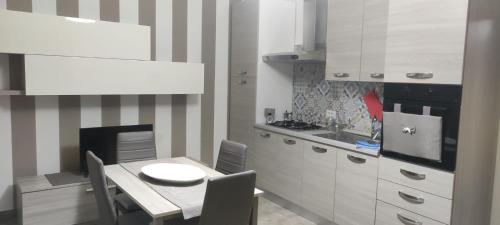a kitchen with a table and a dining room at Villa Giasi in Floridia