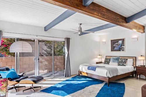 a bedroom with a bed and a large window at On The Rocks in Palm Springs