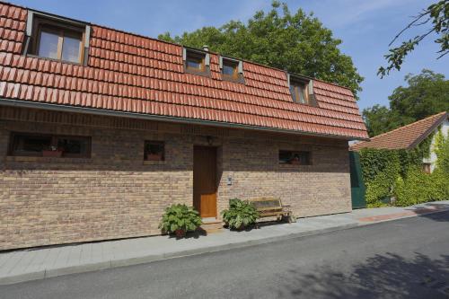 a brick building with a bench in front of it at Penzion Cihelna in Brno