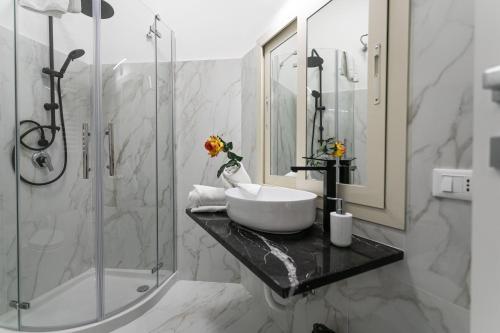 a bathroom with a sink and a shower at Re di Roma Rooftop in Rome