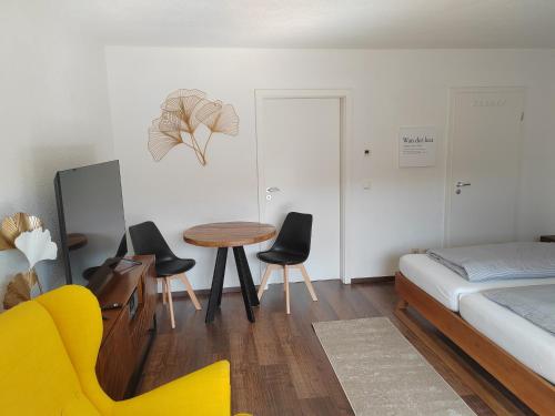 a bedroom with a bed and a table and chairs at Ferienwohnung Elbtraum in Pirna