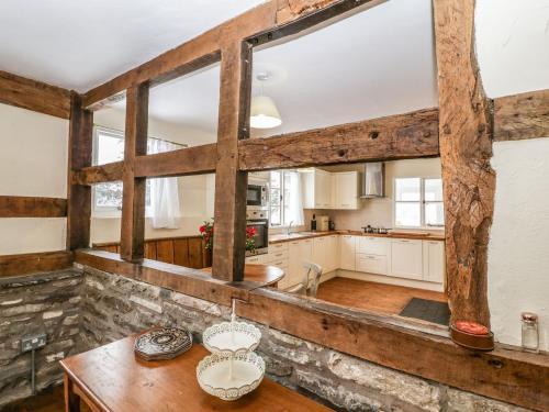 a kitchen with a table and some windows at The Old Rectory in Presteigne