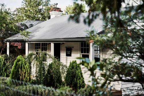 a white house with a black roof at Chaplet Cottage Luxury Healesville Cottage in Healesville