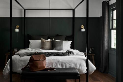 a black and white bedroom with a large bed at Chaplet Cottage Luxury Healesville Cottage in Healesville