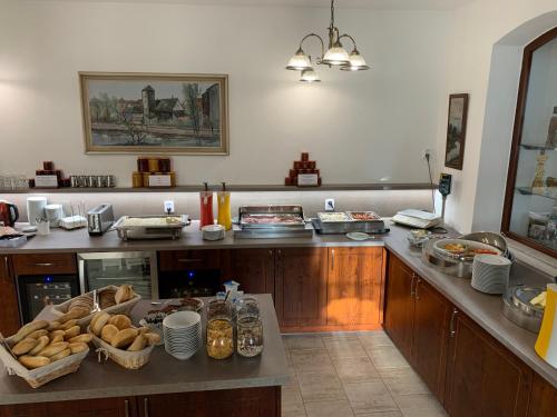 a kitchen with a counter with food on it at Penzion Eduard in Františkovy Lázně