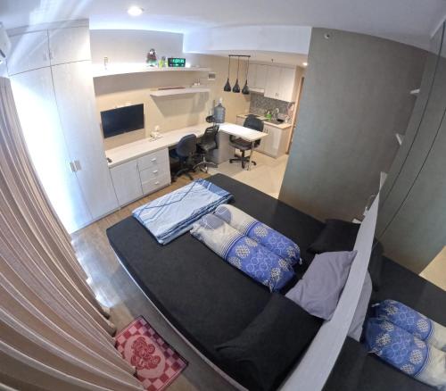 a view of a bedroom with a bed and a desk at Student Park 606 by We Stay in Seturan