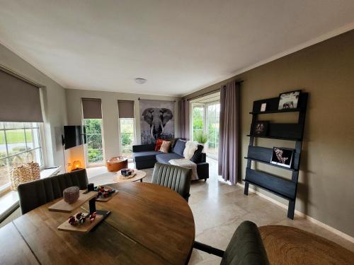 uma sala de estar com uma mesa de madeira e um sofá em Secret Wellness Lonneker em Enschede