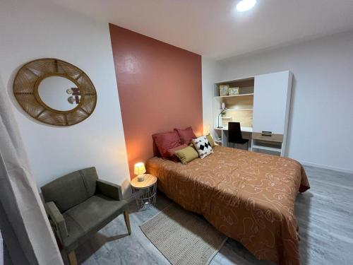 a bedroom with a bed and a chair and a mirror at LeRelaisdOdile * APPARTEMENT PARTAGE Spacieux & Lumineux * in Cambrai