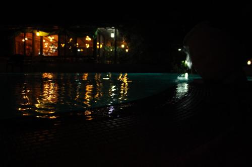 a pool of water at night with a building in the background at Arbel Guest House Shavit Family in Arbel
