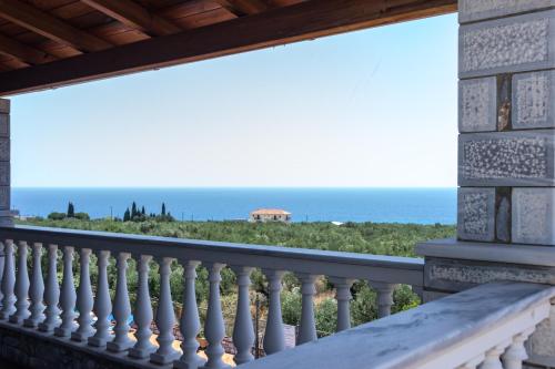a balcony with a view of the ocean at Amalia Apartments in Stoupa