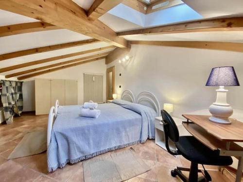 a bedroom with a bed with a table and a desk at CASA FIORITA in Predaia