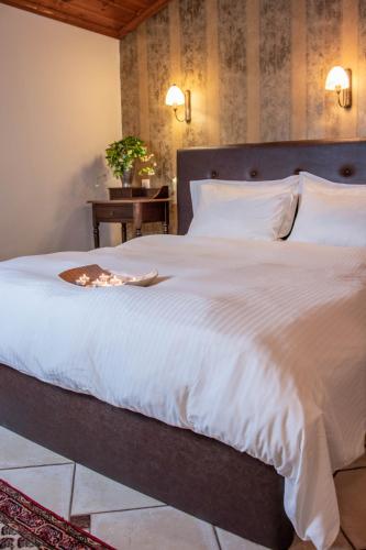 a bedroom with a large bed with a white comforter at Hagiati Anastasiou Hotel & Spa in Naousa Imathias
