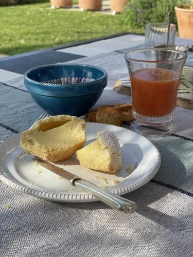a table with a plate of food and a cup of tea at Masseria Spartivento in Conca Specchiulla