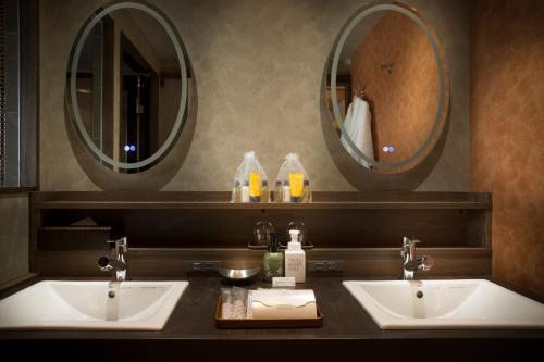 two sinks in a bathroom with two mirrors at Sakaeya in Yamanouchi