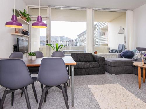 a living room with a table and chairs at 6 person holiday home on a holiday park in Fanø in Fanø