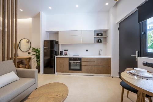 a kitchen and living room with a couch and a table at Apollon City Suites in Kos Town