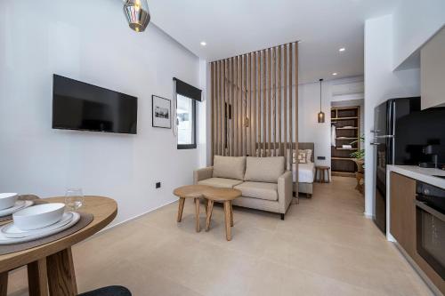 a living room with a couch and a table at Apollon City Suites in Kos Town