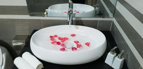 a bathroom with a sink with hearts in the water at Villa Pearl FLCSầm Sơn in Sầm Sơn