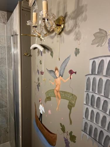 a bathroom with a painting of a fairy on the wall at B&B Els 