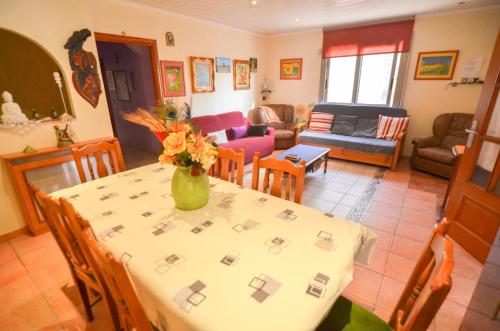 a living room with a table with a vase of flowers on it at Club Villamar - Apartment Amity in Maçanet de la Selva