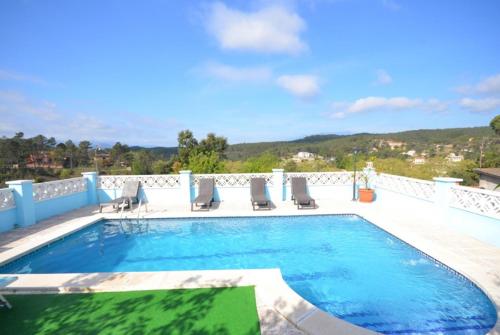 a swimming pool with lounge chairs at Club Villamar - Apartment Amity in Maçanet de la Selva