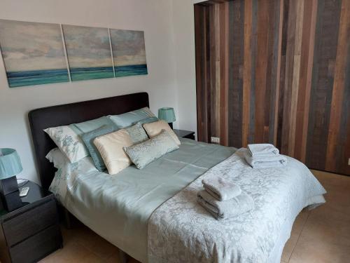 a bedroom with a large bed with towels on it at Casa Pino Solo in Iznájar