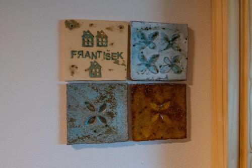 a group of four tiles hanging on a wall at Penzion - Vinařství Hanuš in Blučina