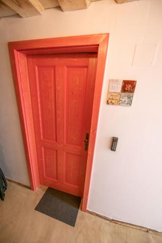 a red door in the corner of a room at Penzion - Vinařství Hanuš in Blučina