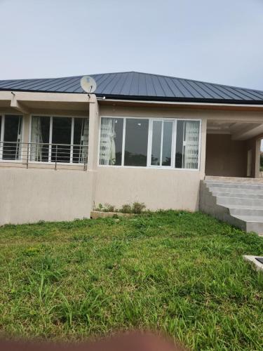 una casa con un tetto solare in cima a un cortile di 3 Bedroom Serene home In Kwahu 