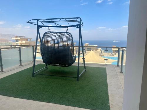 a bird cage sitting on top of a balcony at Tolip Resort El Galala Hills in Ain Sokhna