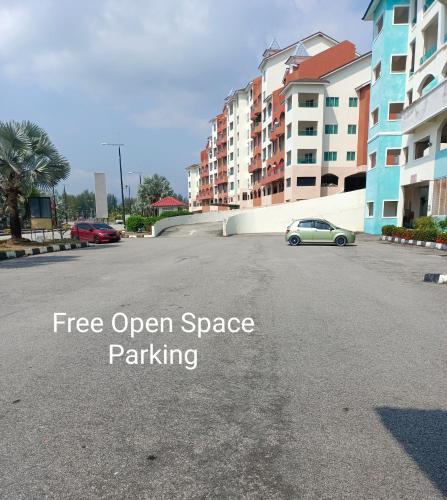 a parking lot with a car parked in the street at Glossy Marina Homestays in Lumut