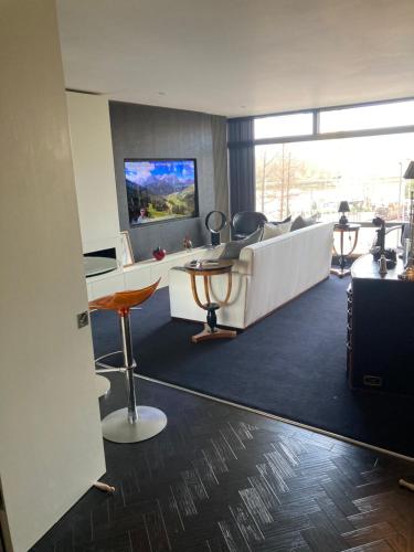 an office with a waiting room with chairs and a tv at Luxury Designer Apartment River view of Parliament Westminster Big Ben. in London