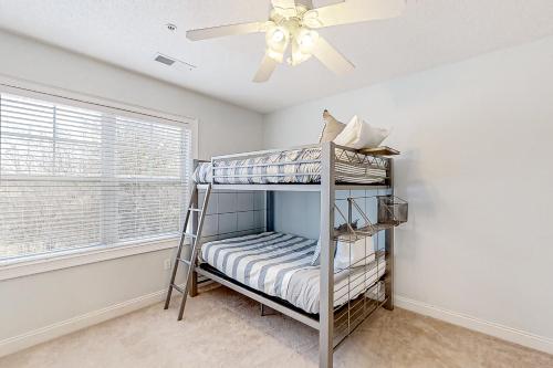 a bedroom with a bunk bed and a ceiling fan at Havens 1123 in North Myrtle Beach