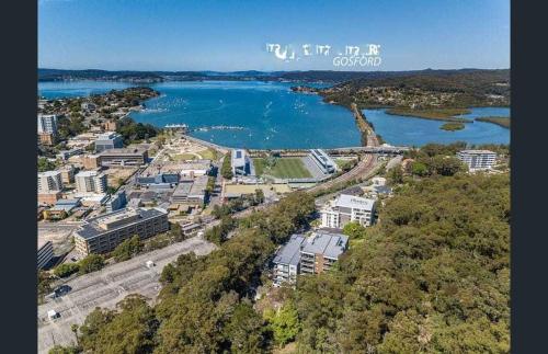 an aerial view of a city and a body of water at Gracious 1930s Art Deco House in Gosford