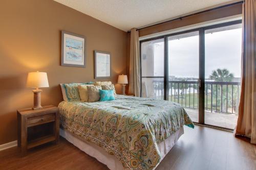 a bedroom with a bed and a large window at Pirates Bay A307 in Fort Walton Beach