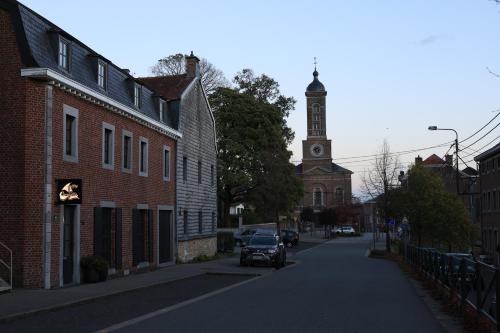 a street in a town with a clock tower at A la Caravelle in Chaineux