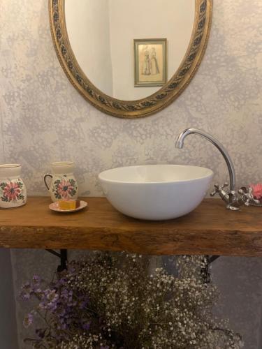 a bathroom with a sink and a mirror at Patios del Agua in El Puerto de Santa María