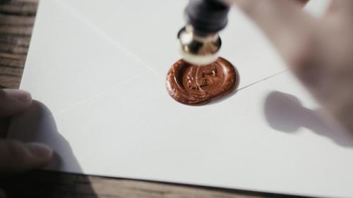 a hand is holding a chocolate sucker on a piece of paper at HARUKA KANATA 森のヴィラ in Minamiboso