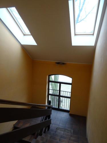 a stairway with skylights in a building with a window at Hostel Miłosz in Grabowiec