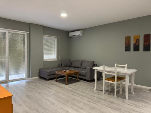 a living room with a couch and a table at Panorama Apartments in Tirana