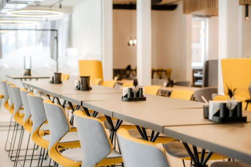 a row of tables and chairs in a room at Bergparadies - inklusive Eintritt in die Alpentherme in Dorfgastein