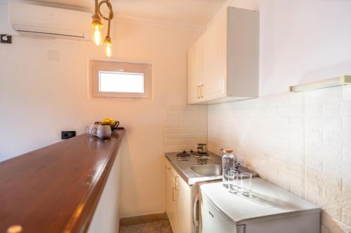 a small kitchen with a sink and a counter at Apartments Klara in Molunat