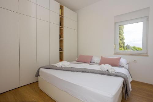 Postel nebo postele na pokoji v ubytování AMAI APARTMENT