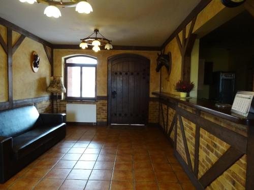a living room with a couch and a door at Hostel Miłosz in Grabowiec