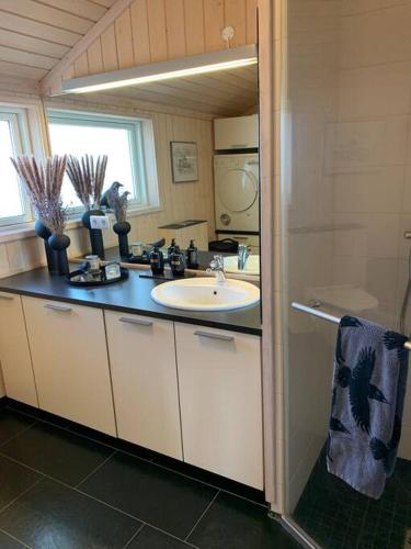 a bathroom with a sink and a counter top at Paradise near Reykjavik w. Sauna - Northern Lights in Mosfellsbær