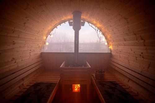 a sauna with a tub in a room with a window at Paradise near Reykjavik w. Sauna - Northern Lights in Mosfellsbær
